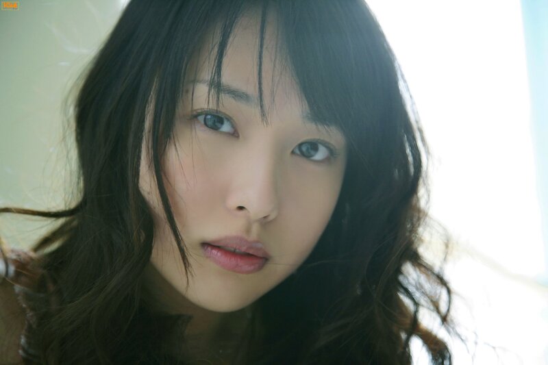 woman with dark hair looking at camera