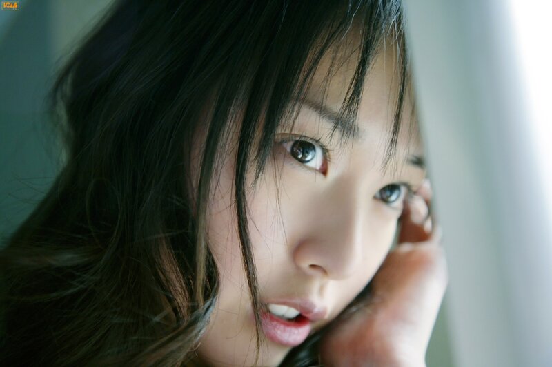 woman with dark hair looking at camera