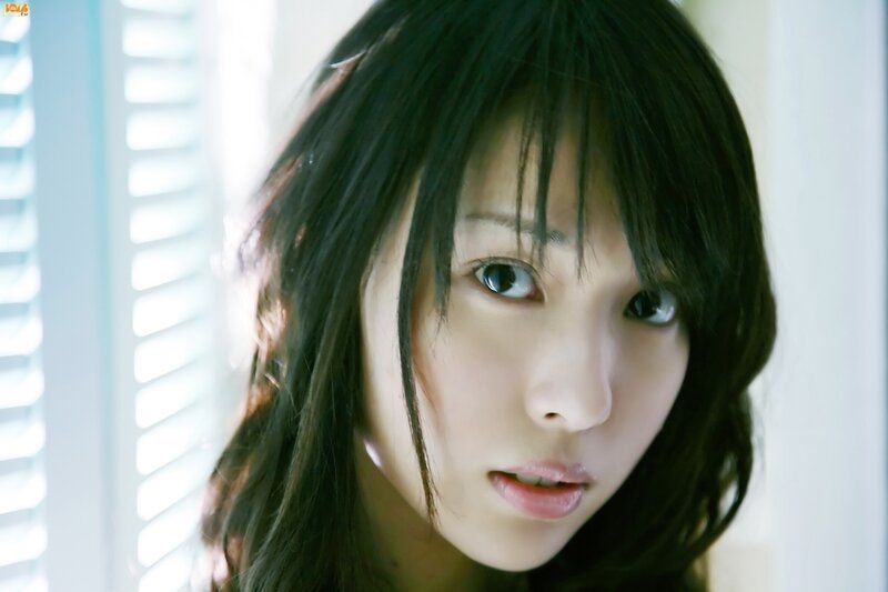 woman with dark hair looking at camera