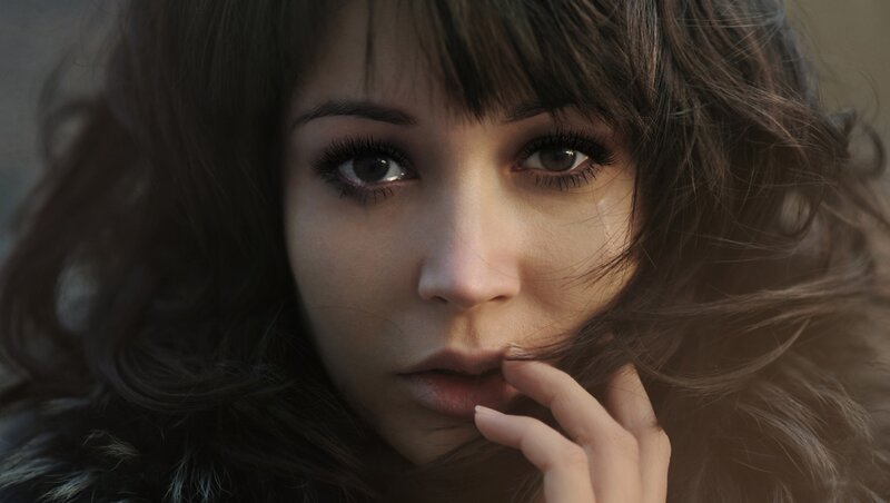 woman with dark hair looking at camera