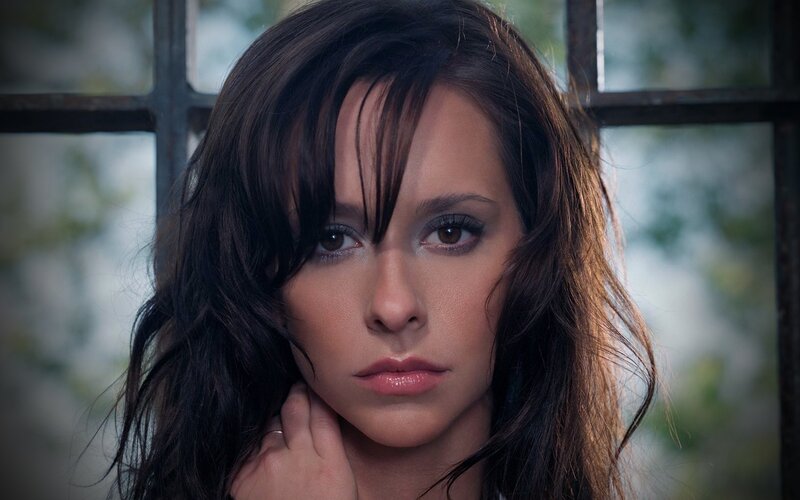 woman with dark hair looking at camera