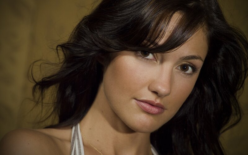 woman with dark hair looking at camera