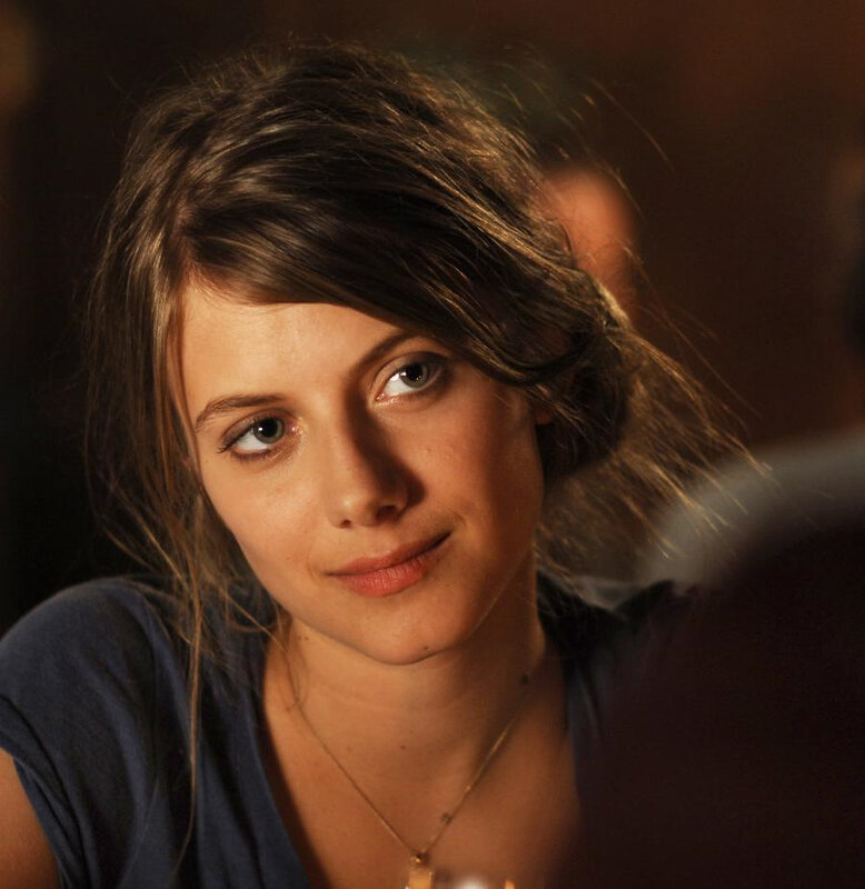 woman with dark hair looking at camera