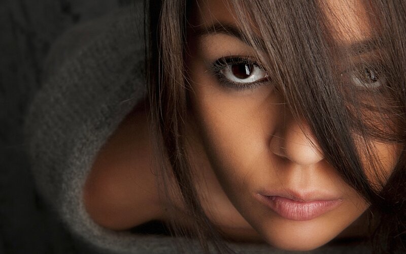 woman with dark hair looking at camera