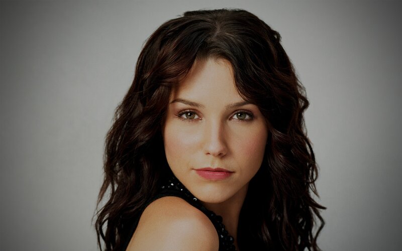 woman with dark hair looking at camera