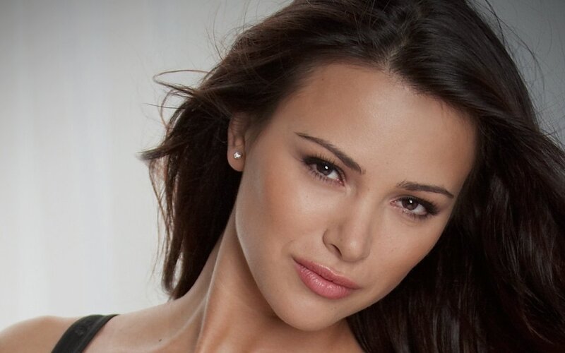 woman with dark hair looking at camera
