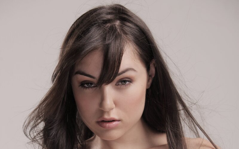 woman with dark hair looking at camera