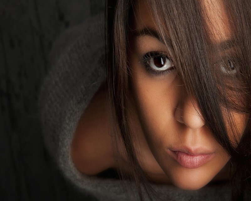 woman with dark hair looking at camera