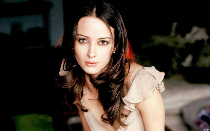 woman with dark hair looking at camera