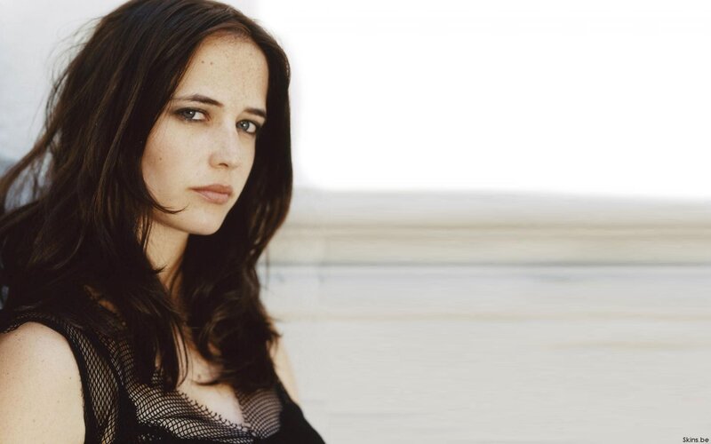woman with dark hair looking at camera