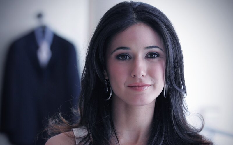 woman with dark hair looking at camera
