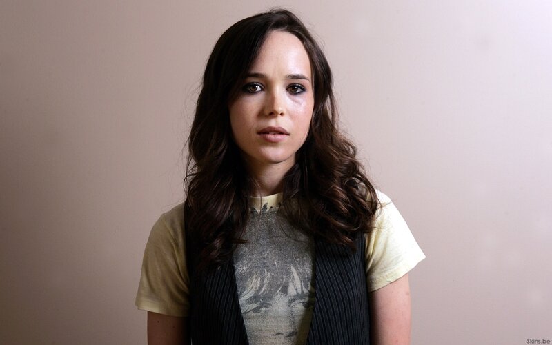 woman with dark hair looking at camera