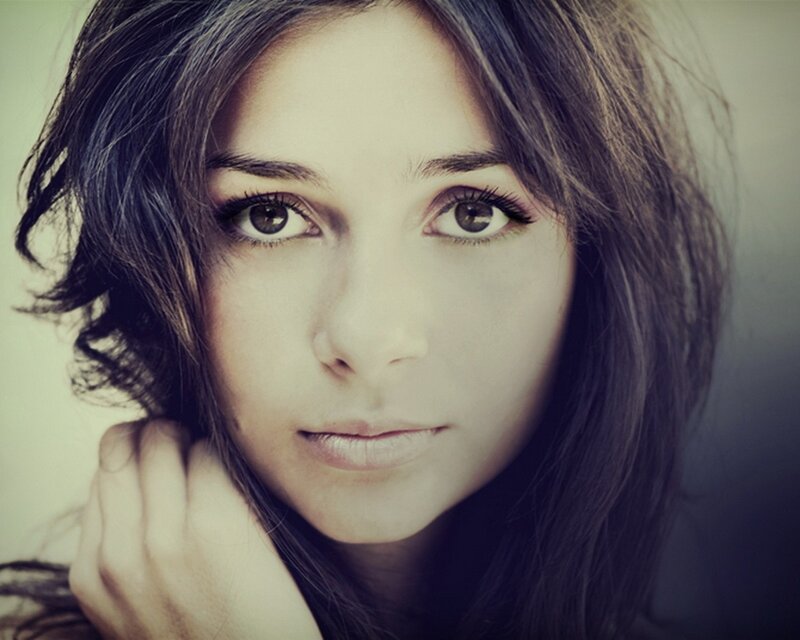 woman with dark hair looking at camera