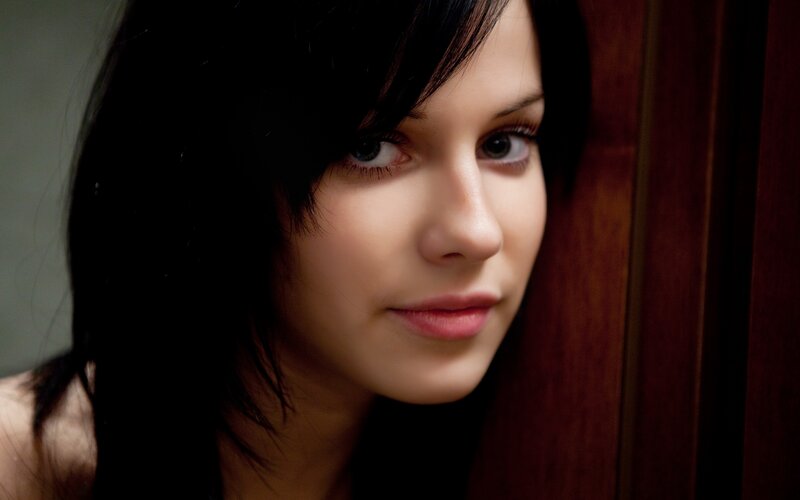woman with dark hair looking at camera