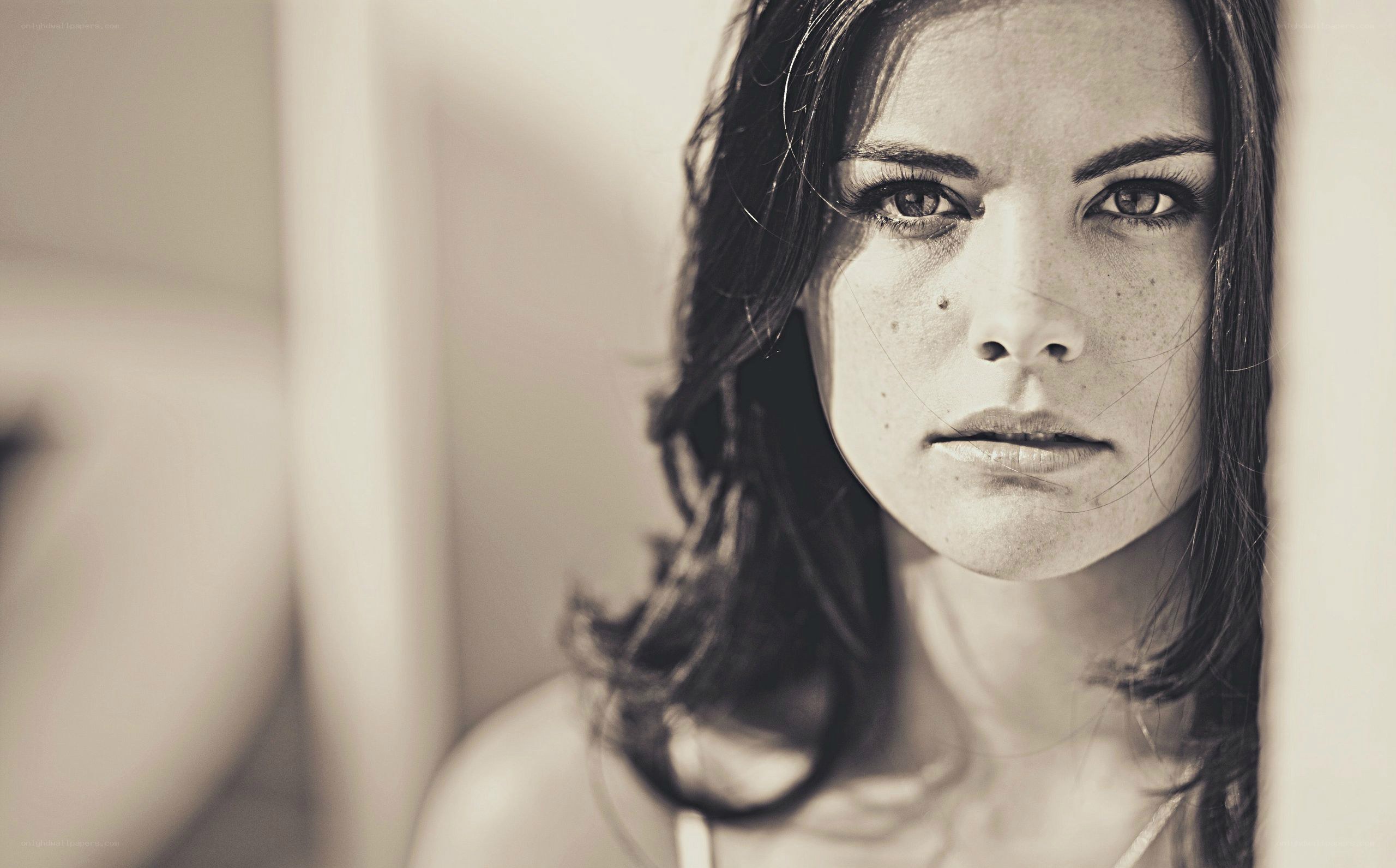 woman with dark hair looking at camera