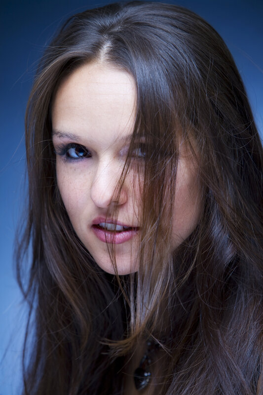 woman with dark hair looking at camera