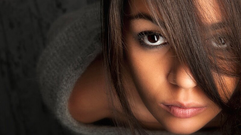 woman with dark hair looking at camera