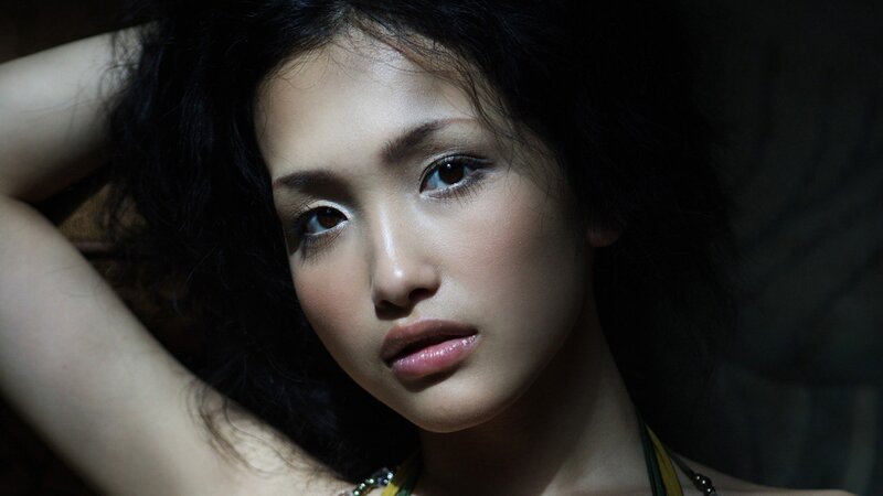 woman with dark hair looking at camera