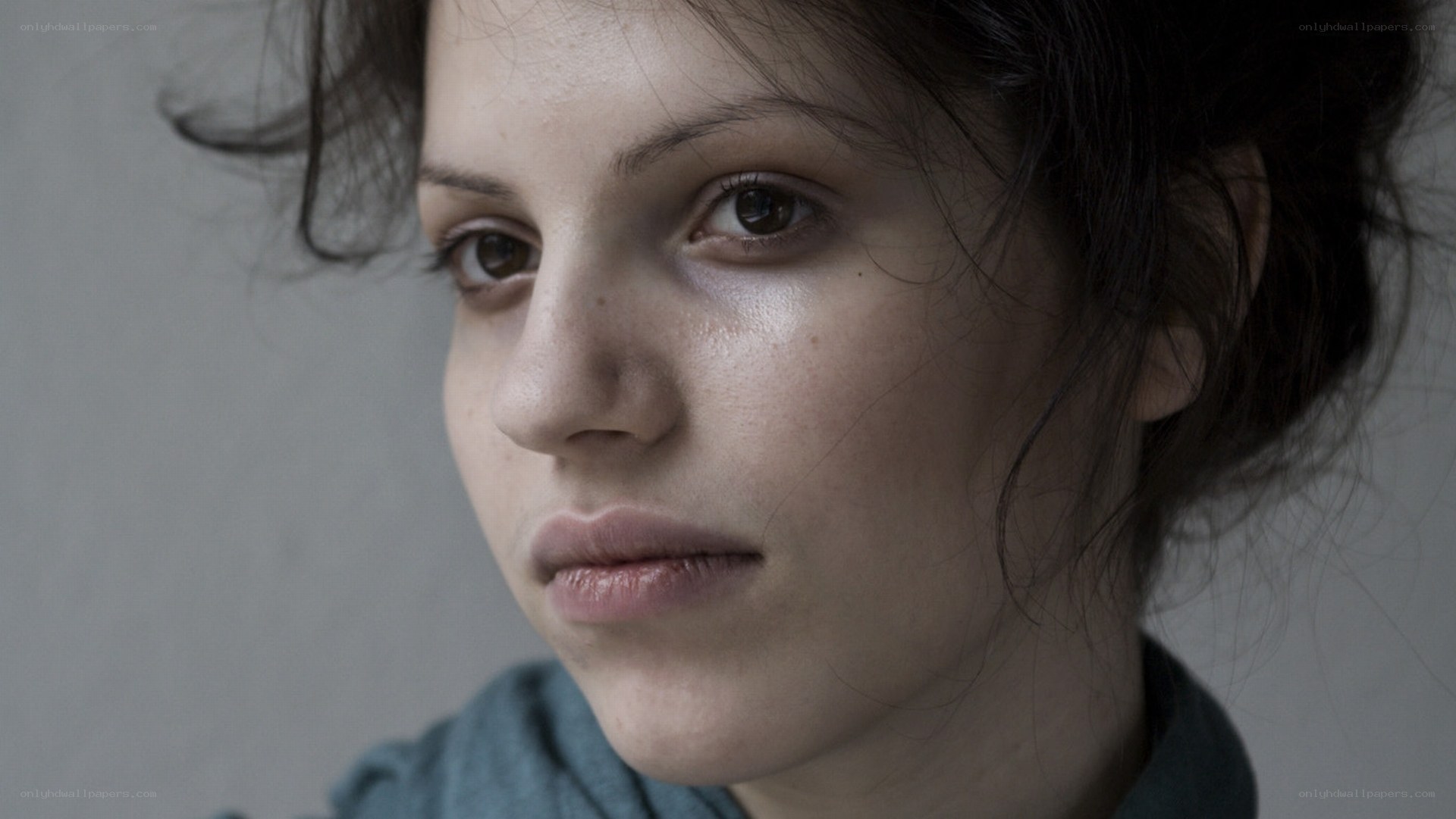 woman with dark hair looking away