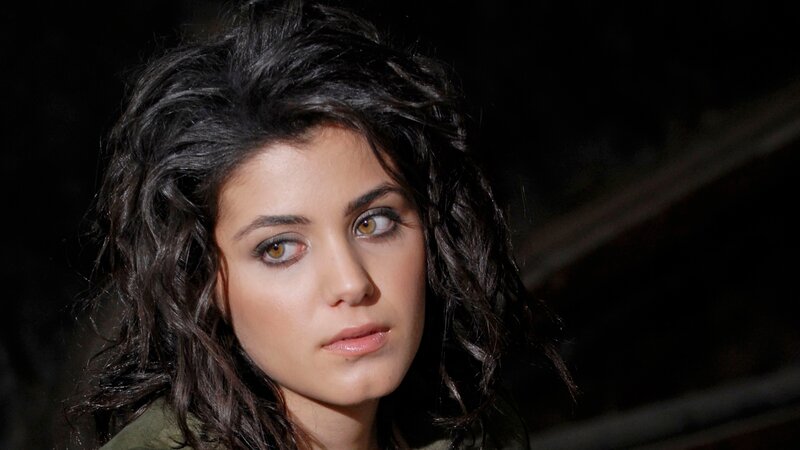 woman with dark hair looking away