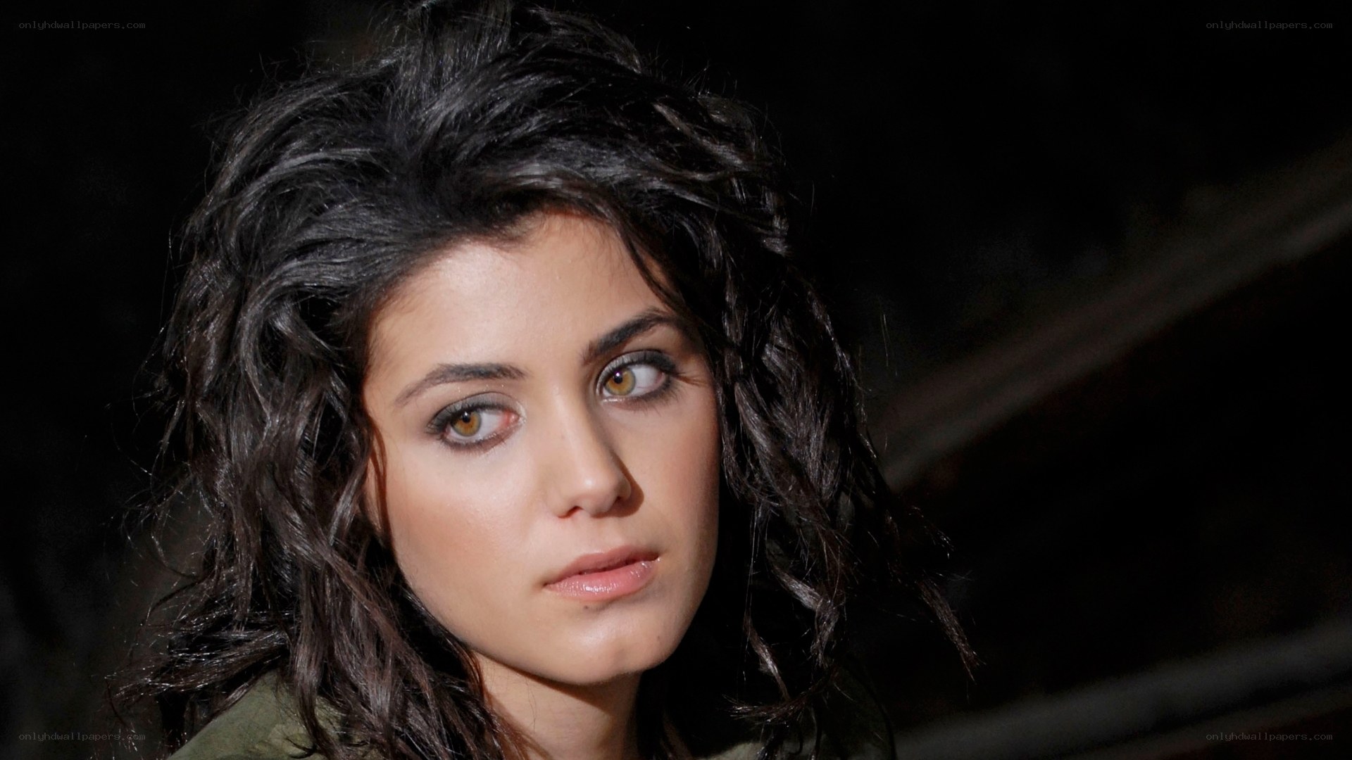 woman with dark hair looking away
