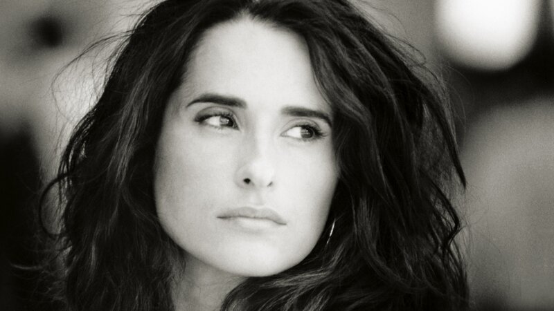 woman with dark hair looking away