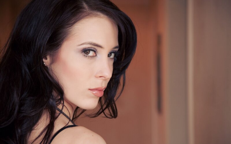 woman with dark hair looking back