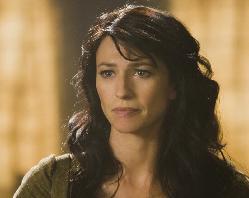 woman with dark hair looking concerned