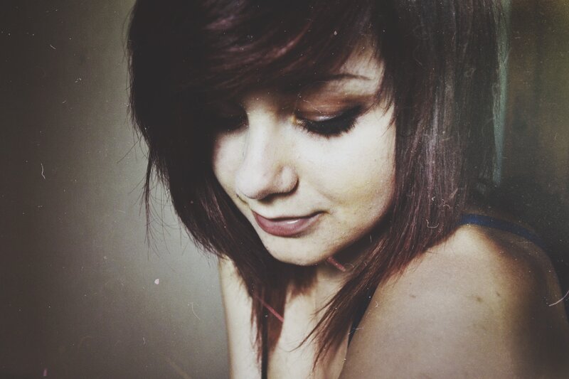 woman with dark hair looking down
