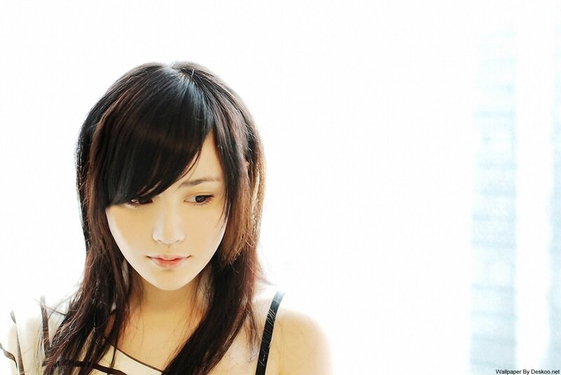 woman with dark hair looking down