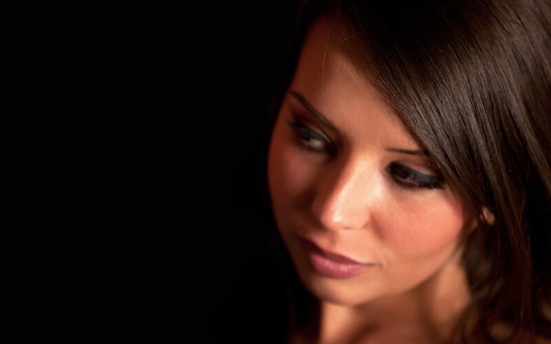 woman with dark hair looking down