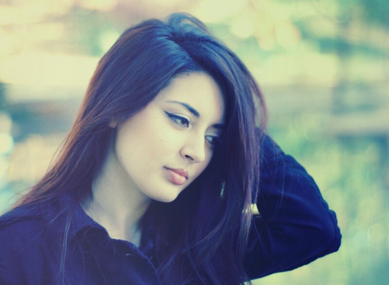 woman with dark hair looking down