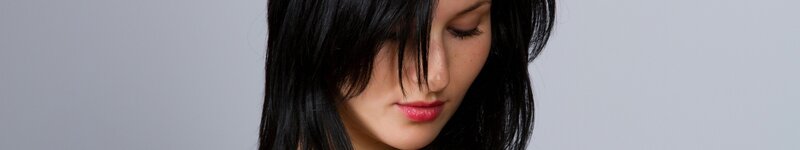 woman with dark hair looking down