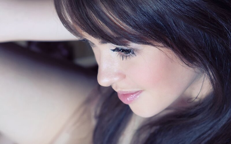 woman with dark hair looking down
