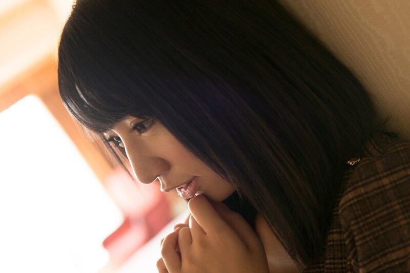 woman with dark hair looking down