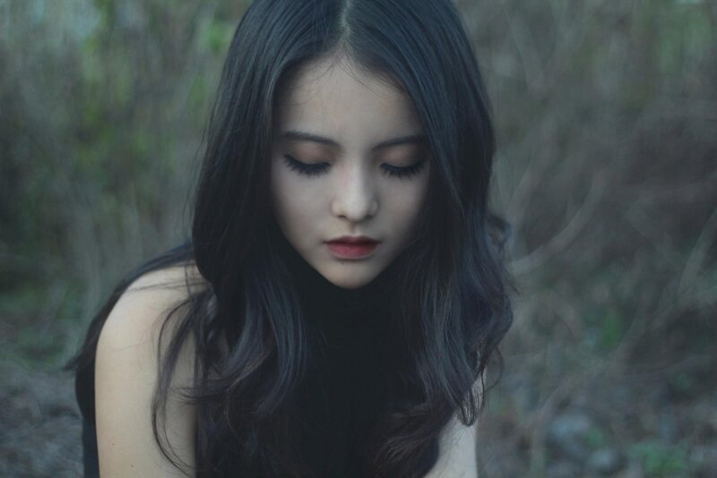 woman with dark hair looking down