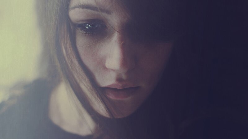 woman with dark hair looking down