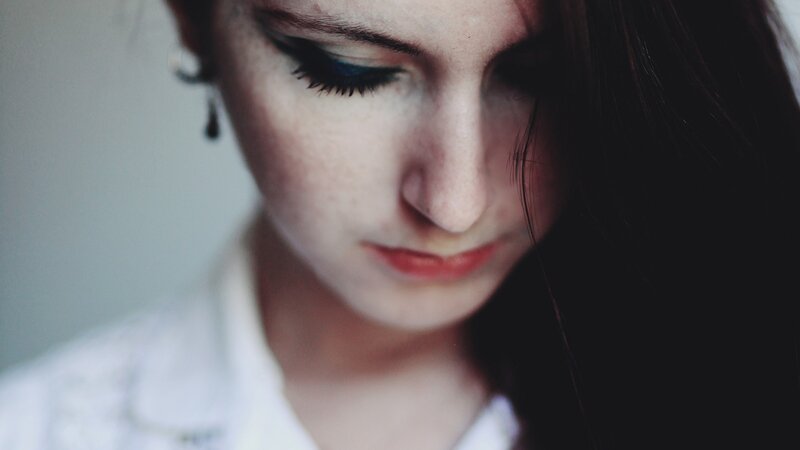 woman with dark hair looking down