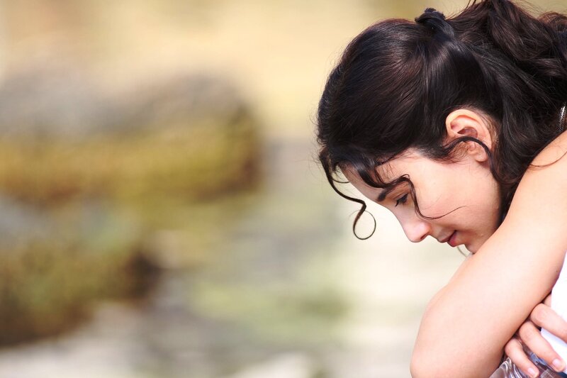 woman with dark hair looking down