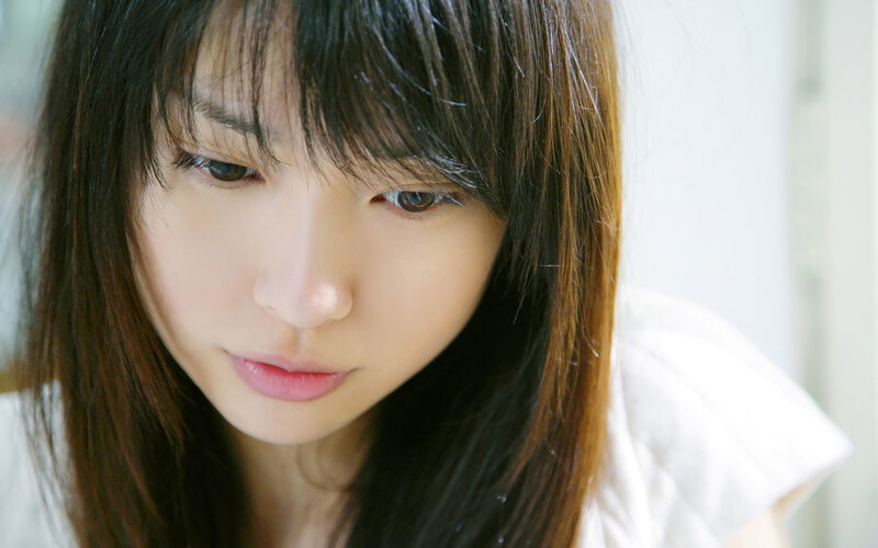 woman with dark hair looking down
