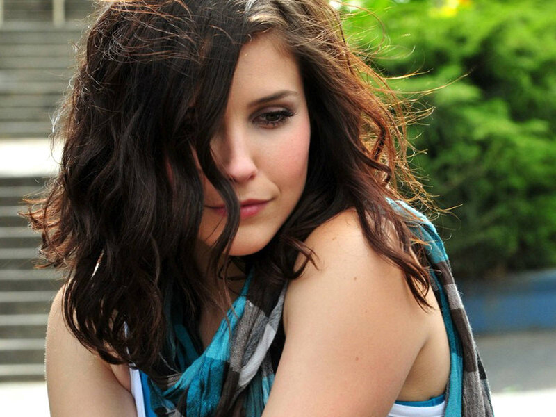 woman with dark hair looking down