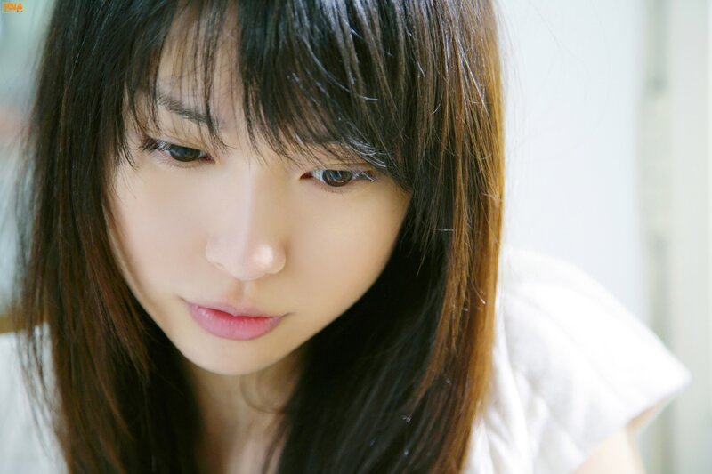 woman with dark hair looking down