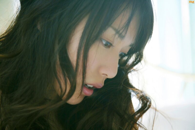 woman with dark hair looking down