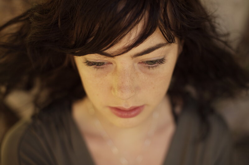 woman with dark hair looking down