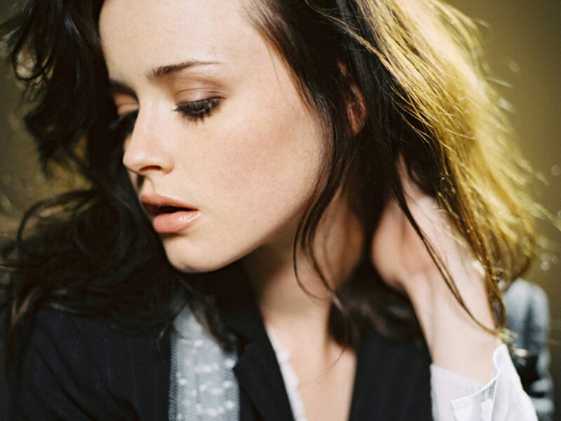 woman with dark hair looking down