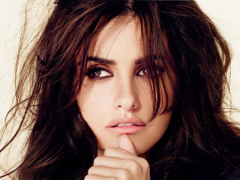 woman with dark hair looking thoughtfully