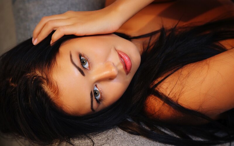 woman with dark hair lying down