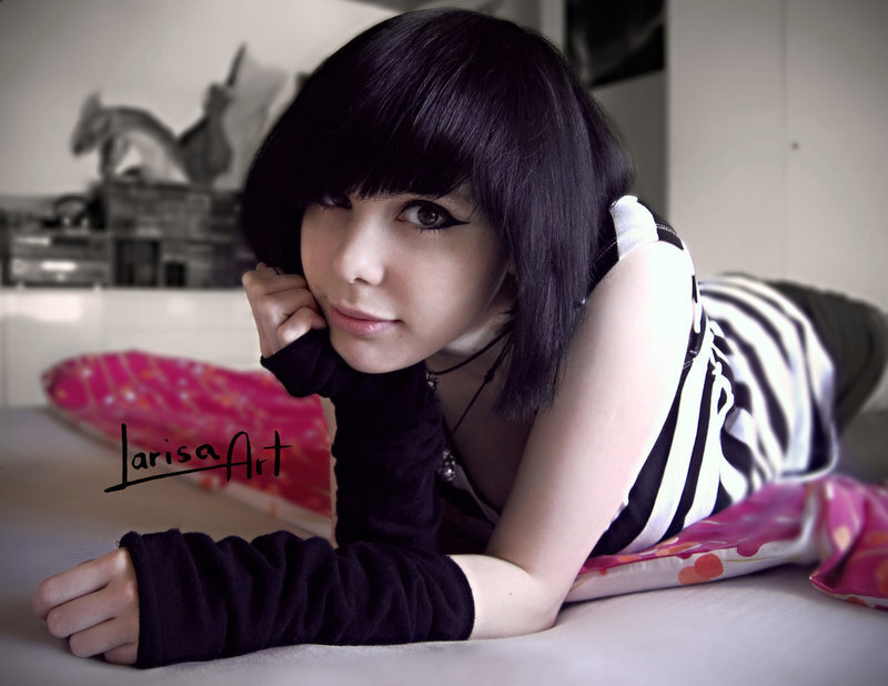 woman with dark hair lying on bed