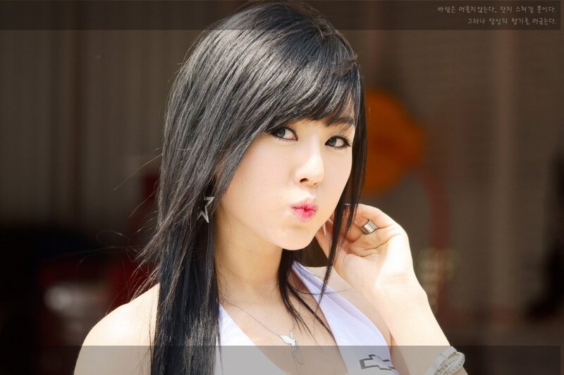 woman with dark hair making a kiss face