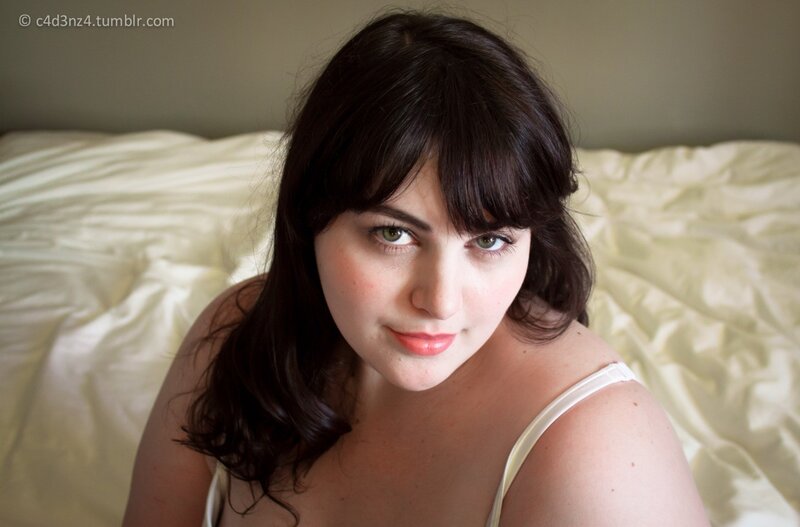 woman with dark hair on bed